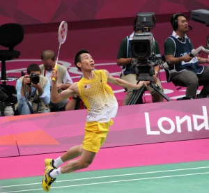 Badminton terms explained with a player preparing to smash during a competitive match