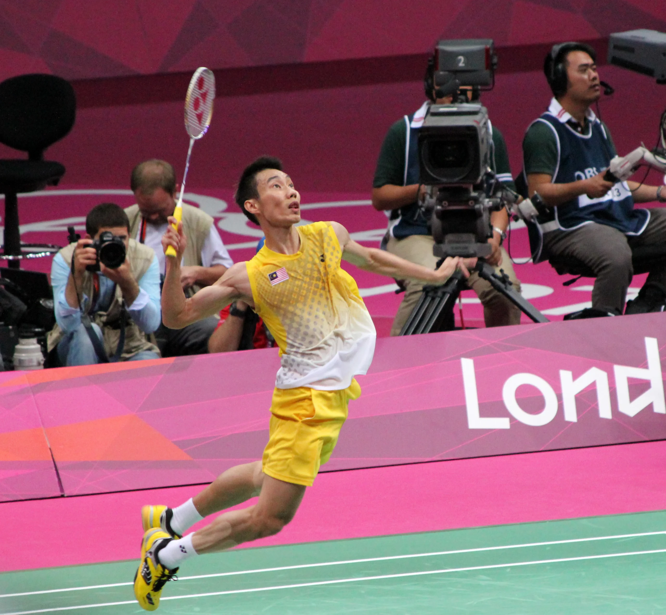 Badminton terms explained with a player preparing to smash during a competitive match