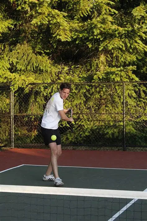 Pickleball player preparing to hit a backhand during a game